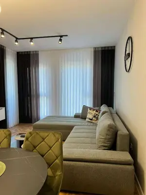 a living room with a couch and a bed at City lux apartment in Plovdiv