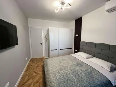 a bedroom with a bed and a ceiling fan at City lux apartment in Plovdiv