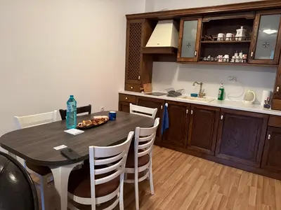 a kitchen with a table and chairs in a kitchen at Donna Spa hotel Sveti Spas in Velingrad