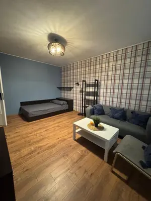 a living room with a couch and a table at Cozy Corner in Nadezhda in Sofia
