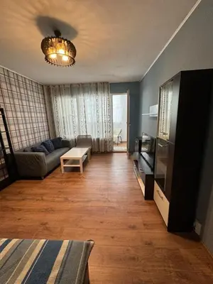 a living room with a couch and a television at Cozy Corner in Nadezhda in Sofia