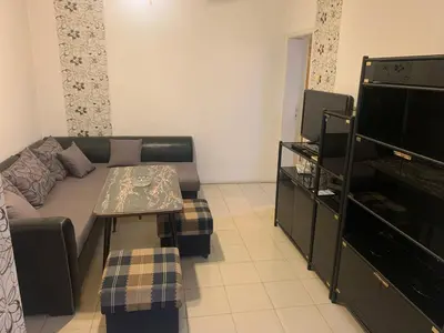a living room with a couch and a tv at West Park Retreat in Sofia