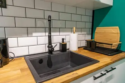 a kitchen sink with a faucet on a counter at Saltwater Apartments in Sandanski