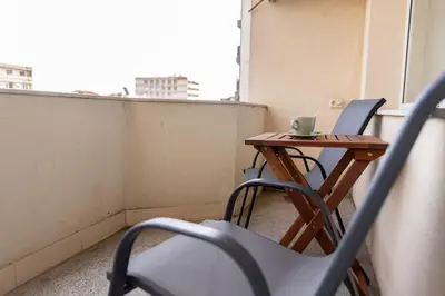 a small table and chairs on a balcony at Saltwater Apartments in Sandanski