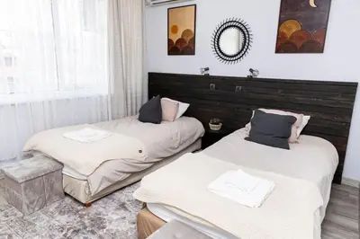 a room with two beds and a mirror at Saltwater Apartments in Sandanski