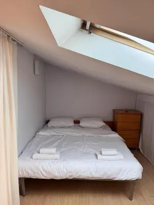 a bedroom with a bed with two towels on it at Sofia Central Cozy Apartment in Sofia