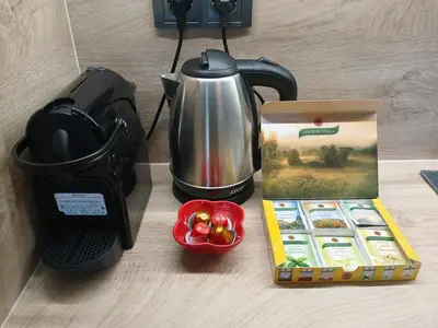 a coffee maker and a kettle and a box of muffins at Studio 42 Plovdiv in Plovdiv
