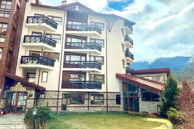 a large white building with balconies on it at Cozy Mountain-View Apartment in Belmont, Bansko by Flat Mаnager in Bansko