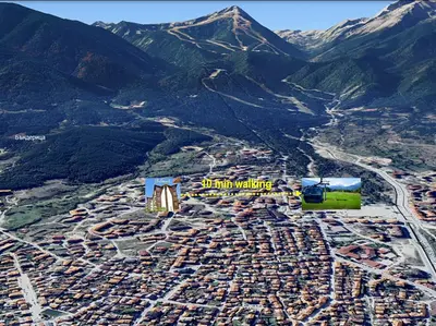 an aerial view of a city with a mountain at Cozy Mountain-View Apartment in Belmont, Bansko by Flat Mаnager in Bansko