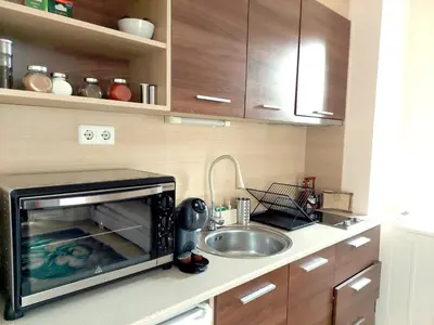 a kitchen with a sink and a microwave at Cozy Mountain-View Apartment in Belmont, Bansko by Flat Mаnager in Bansko