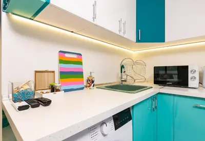 a kitchen with blue cabinets and a sink at Plovdiv Urban Gem Studio by Flat Mаnаger in Plovdiv