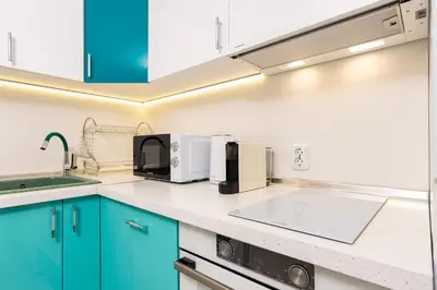 a kitchen with blue cabinets and a sink at Plovdiv Urban Gem Studio by Flat Mаnаger in Plovdiv