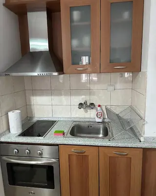 a kitchen with a sink and a stove at Ski Lift Apartment in Bansko