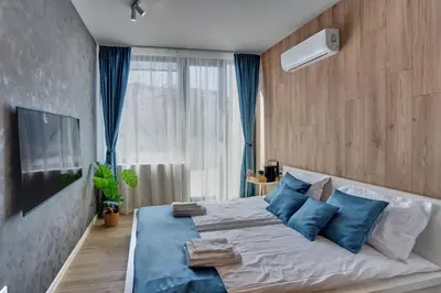 a bedroom with a large bed with blue pillows at Toronto Cozy Studio near UNSS and NSA w Fast WiFi in Sofia