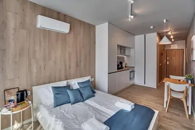 a bedroom with a bed and a table and a kitchen at Toronto Cozy Studio near UNSS and NSA w Fast WiFi in Sofia