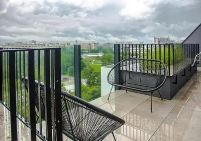 a balcony with a chair and a view of a city at Toronto Cozy Studio near UNSS and NSA w Fast WiFi in Sofia