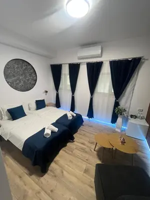 a bedroom with a large bed and a table at BoxRoom3 in Kyustendil