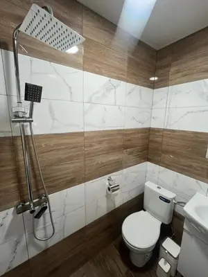 a bathroom with a toilet and a sink and a shower at BoxRoom3 in Kyustendil