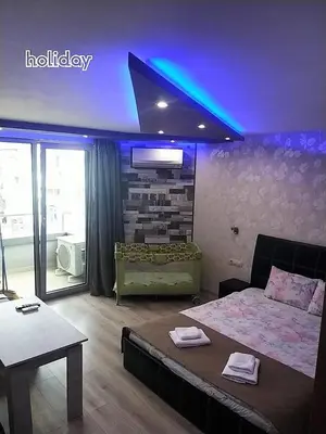 a bedroom with a bed and a blue light at 