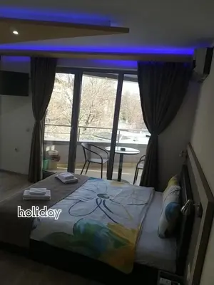 a bedroom with a bed with a blue light above it at 