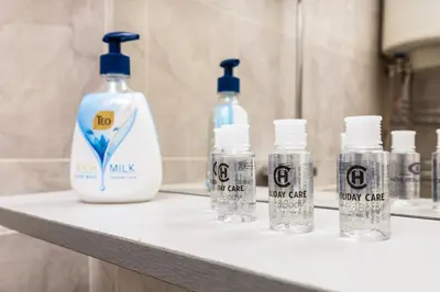 four bottles of detergent sitting on a counter in a bathroom at 1-Bedroom Flat with Balcony in Plovdiv by Flat Mаnager in Plovdiv