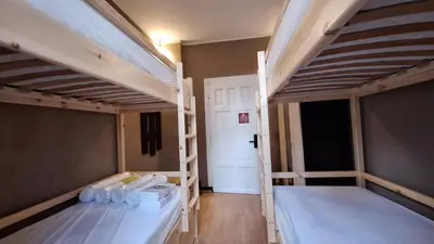 a room with two bunk beds and a hallway at Key Hostel Serdika in Sofia