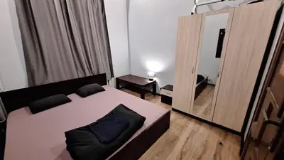 a small bedroom with a bed and a mirror at Key Hostel Serdika in Sofia