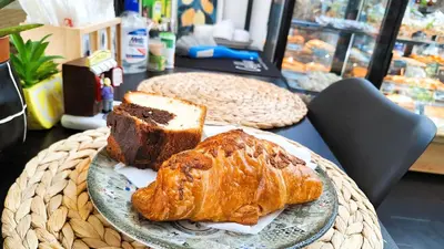 a plate with bread and croissants on a table at Key Hostel Serdika in Sofia