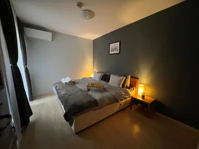 a bedroom with a large bed and a lamp at 2-room Forest Retreat - Fireplace, Veranda, BBQ, Views in Bansko
