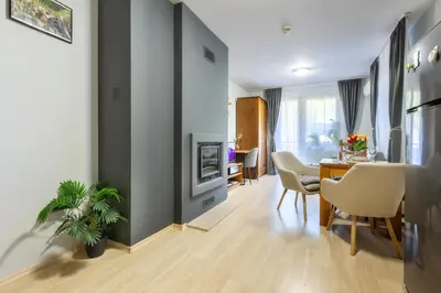 a dining room and living room with a table and chairs at 2-room Forest Retreat - Fireplace, Veranda, BBQ, Views in Bansko