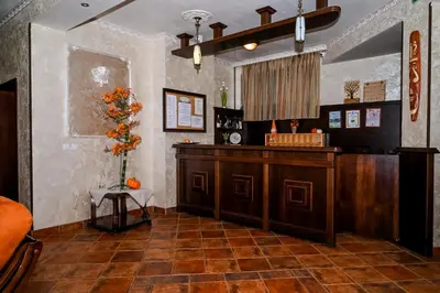 a restaurant with a counter and a vase of flowers at Хотел Валентино 2 in Dobrinishte