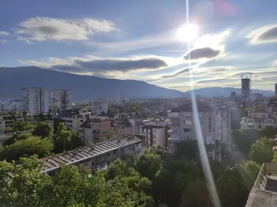 a view of a city with the sun in the sky at Apartment Sofia View with Rooftop Terrace in Sofia