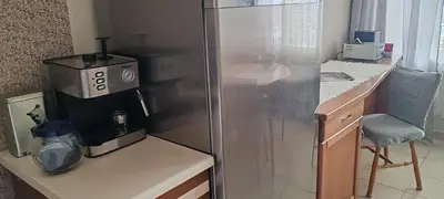 a kitchen with a refrigerator and a table with a blender at Apartment Sofia View with Rooftop Terrace in Sofia