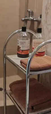 two bottles ofodorizers sitting on a rack in a bathroom at Apartment Sofia View with Rooftop Terrace in Sofia