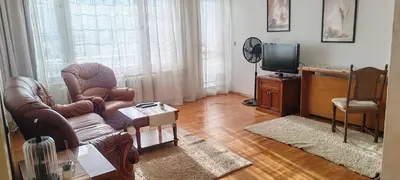 a living room with a couch and a tv at Apartment Sofia View with Rooftop Terrace in Sofia
