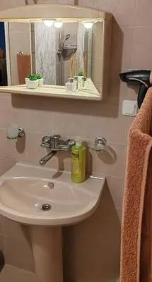 a bathroom with a sink and a mirror at Apartment Sofia View with Rooftop Terrace in Sofia