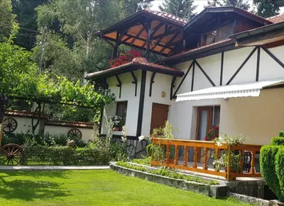 a house with a fence and a yard at Лазов in Sapareva Banya