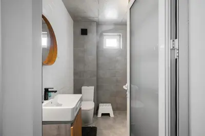 a bathroom with a white sink and a toilet at Bright and Cozy 1BD Apartment plus Desk by Flat Mаnаger in Sofia