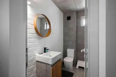 a bathroom with a sink and a toilet and a mirror at Bright and Cozy 1BD Apartment plus Desk by Flat Mаnаger in Sofia