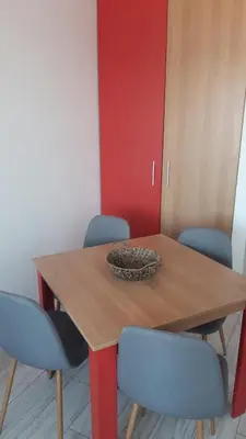 a wooden table with blue chairs and a bowl on top at ТЕС Боровец Гарденс in Borovets