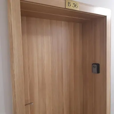 a wooden door with a sign on top of it at ТЕС Боровец Гарденс in Borovets