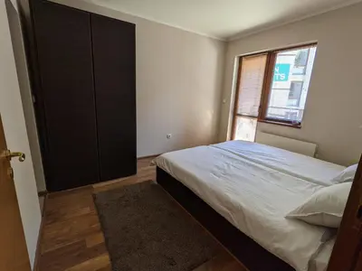 a bedroom with a large bed and a window at Spacious modern 1BR apartment near the gondola in Bansko