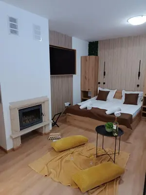 a large bedroom with a bed and a fireplace at Апартаменти Pamporovo Dream в Гранд Ризорт Пампорово in Pamporovo