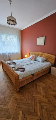 a large bed in a bedroom with red walls at Elegant and cozy apartment in Sofia
