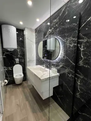 a bathroom with a sink and a toilet and a mirror at Center Park Apartment in Sandanski
