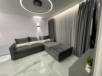 a living room with a couch and a table at Center Park Apartment in Sandanski