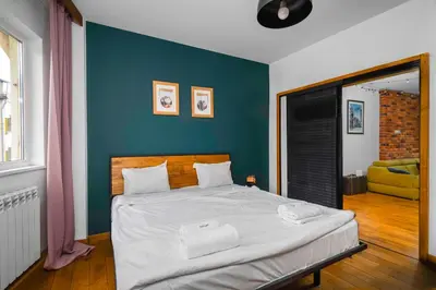a bedroom with a large bed with a blue wall at Central Sanctuary 3BD by Flat Mаnаger in Sofia