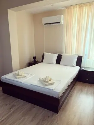 a bedroom with a bed with two towels on it at Victoria apartment - Sandanski in Sandanski