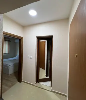 a room with a mirror and a bed in it at Victoria apartment - Sandanski in Sandanski
