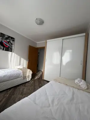 a bedroom with two beds and a large closet at Tanov Cozy Place in Blagoevgrad